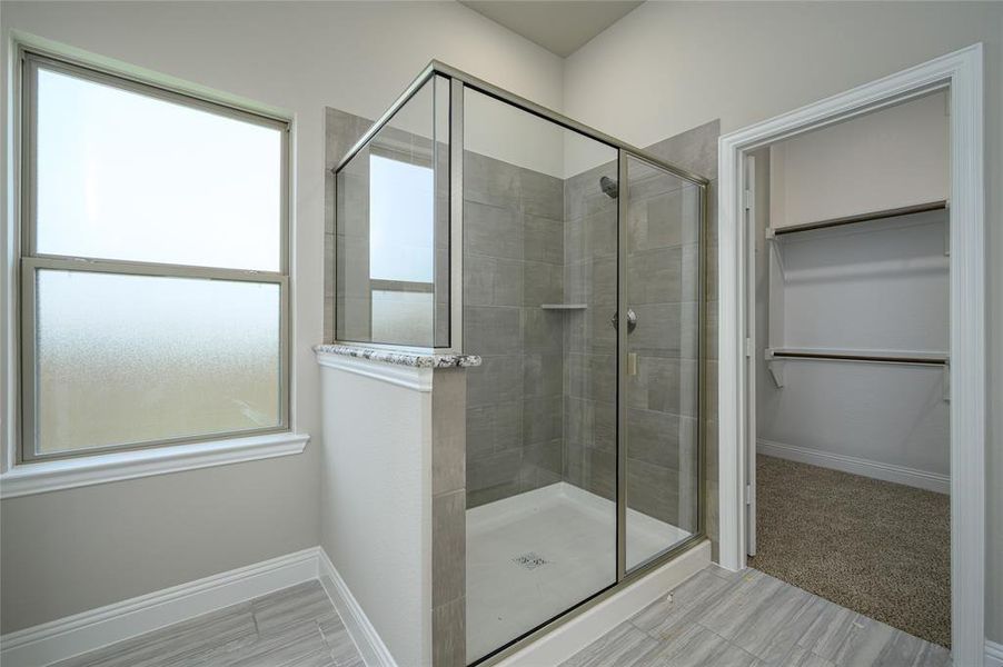 Bathroom featuring an enclosed shower and tile patterned floors