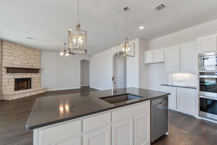 Kitchen & Family Room | Concept 2406 at Hidden Creek Estates in Van Alstyne, TX by Landsea Homes