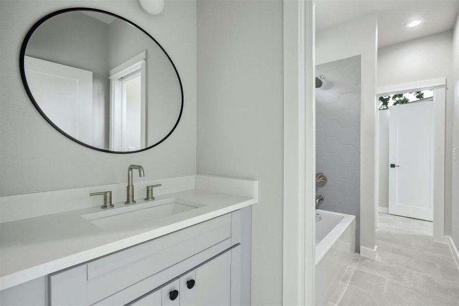 Bright and airy, the guest bathroom boasts ample natural light, creating an inviting atmosphere that ensures guests feel comfortable and at home during their stay.