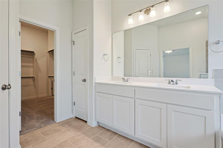 Bathroom featuring tile patterned flooring and vanity