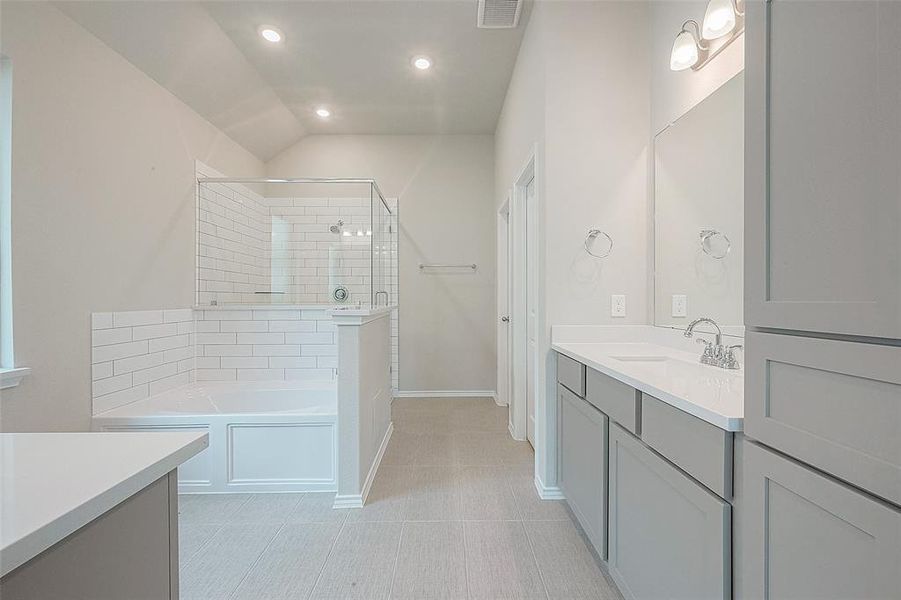 Indulge in the ensuite bathroom complete with a spa-like soaking tub, dual vanity and walk-in shower.