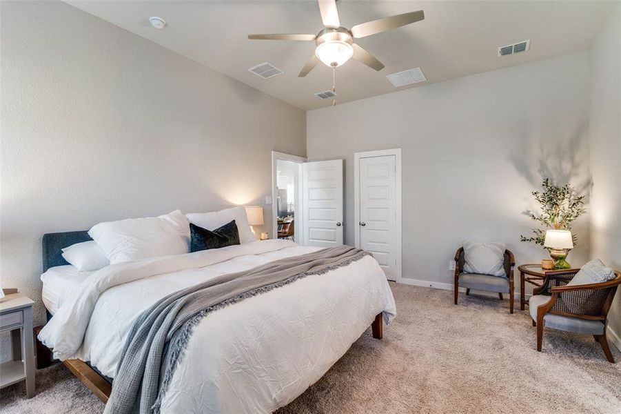 Carpeted bedroom with ceiling fan