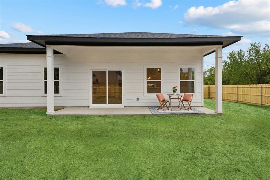 Back of property featuring a fenced yard and a patio