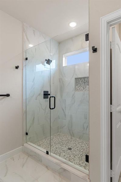 Bathroom featuring tile patterned floors and an enclosed shower