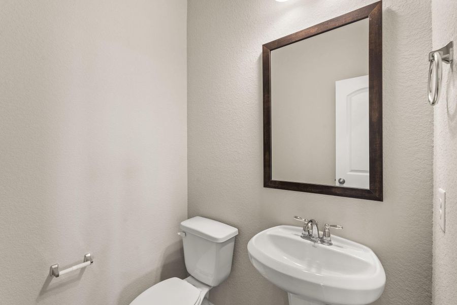 The first floor powder room is conveniently located close to the main living space.