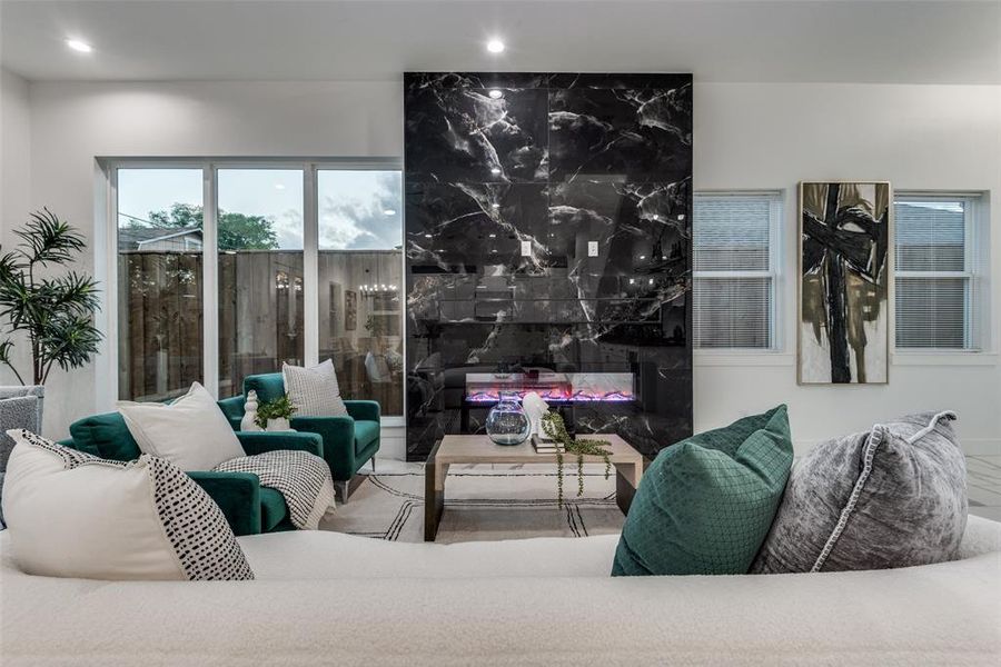 Floor to ceiling black marble fireplace.