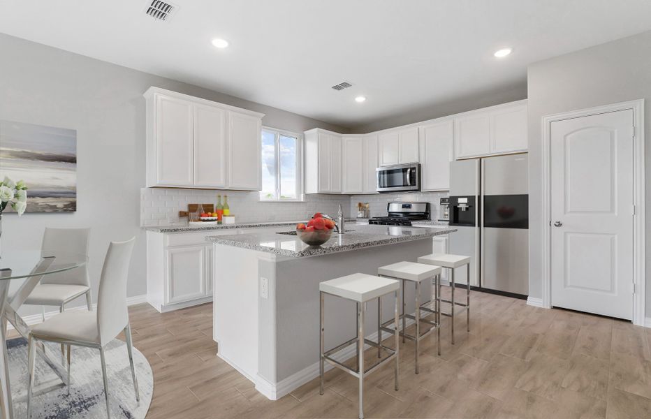 Spacious island kitchen with recessed lighting