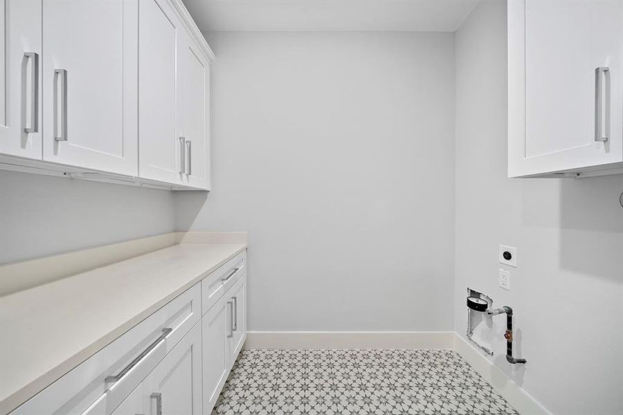 Utility room with connections for gas dryer.