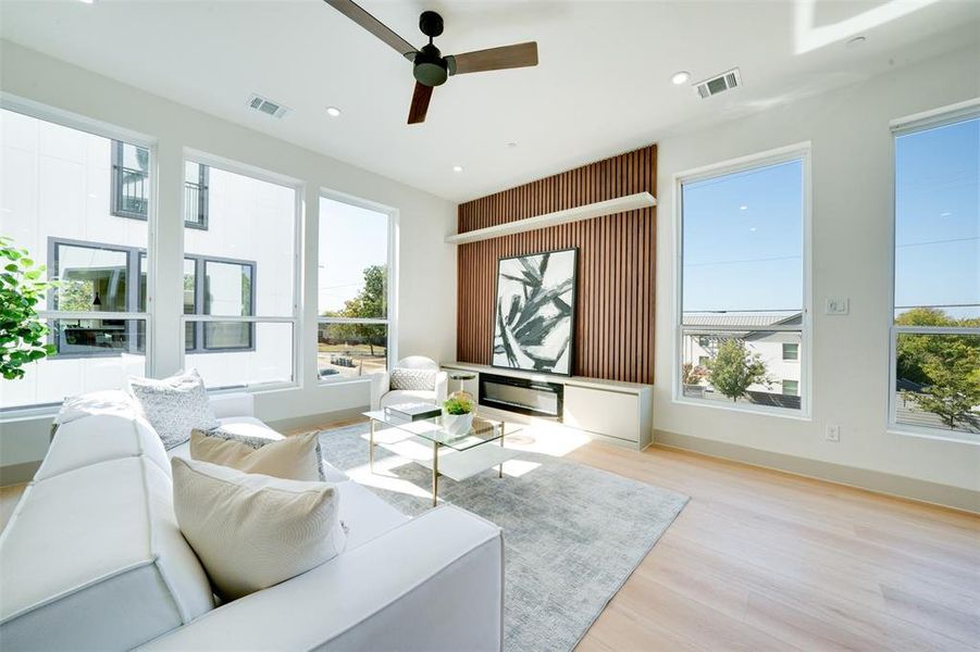 Living room featuring light wood-type flooring and ceiling fan