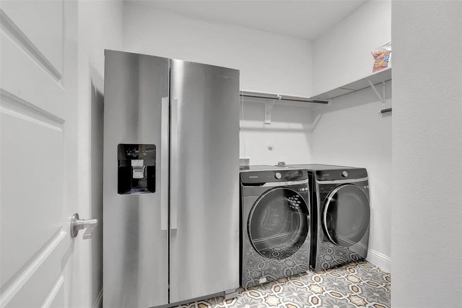 Washroom featuring tile patterned flooring and washer and dryer