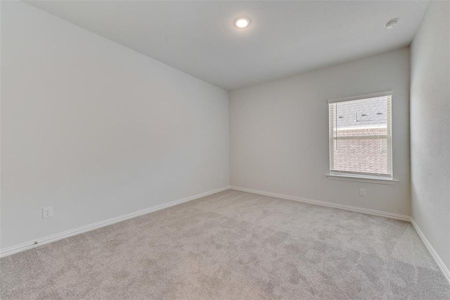 Unfurnished room with light colored carpet