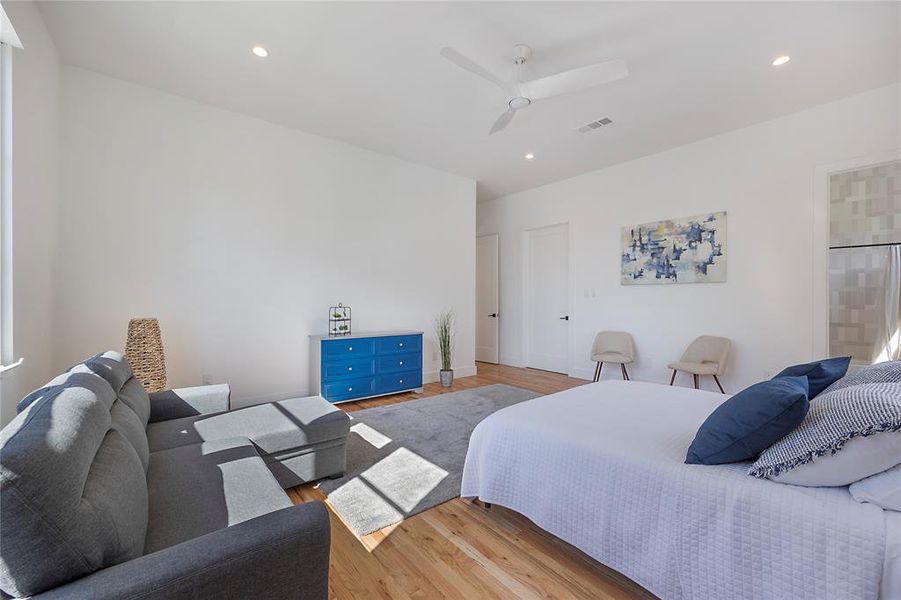 Bedroom with ceiling fan and light hardwood / wood-style flooring