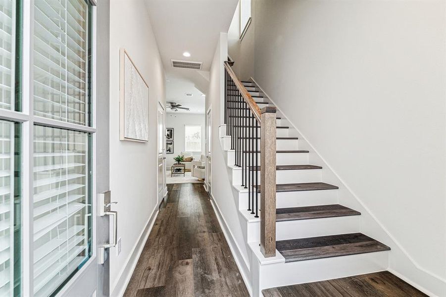 Step inside and be greeted by highceilings, LED recessed can lighting,soothing paint colors and stylishwood railing with iron spindles on thestairway.