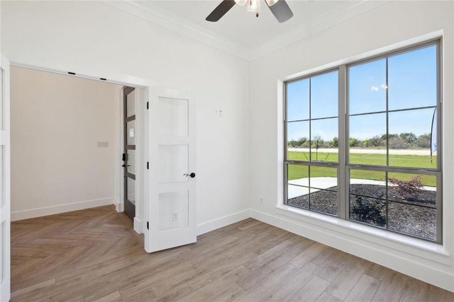 Spare room featuring crown molding and ceiling fan