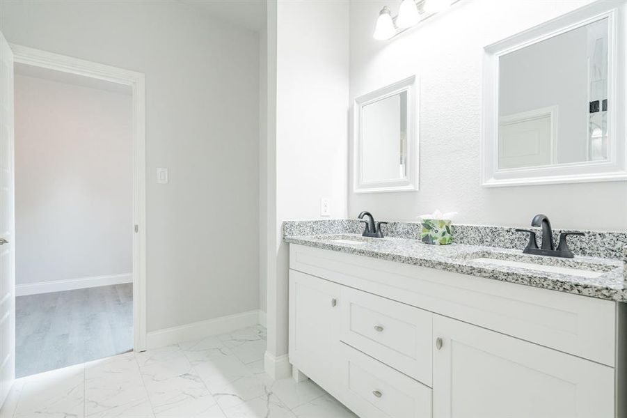 Kitchen with stainless steel appliances, light hardwood / wood-style floors, tasteful backsplash, and a kitchen island