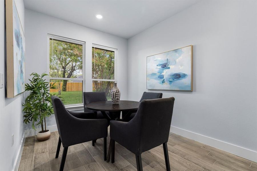 Dining room with light hardwood / wood-style flooring