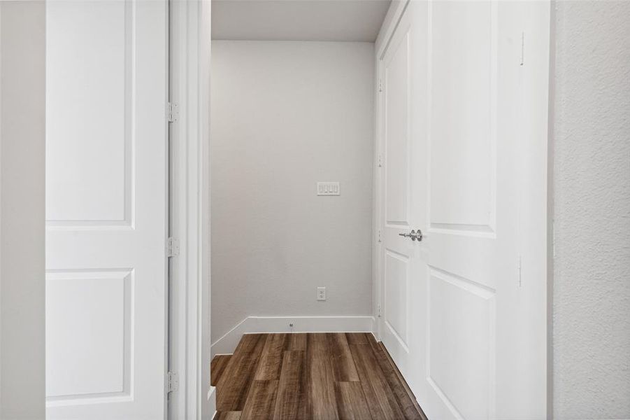 Corridor with hardwood / wood-style flooring