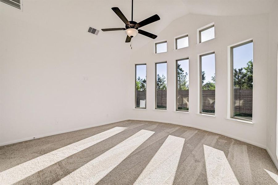 Bay windows and vaulted ceiling accentuate the primary bedroom.