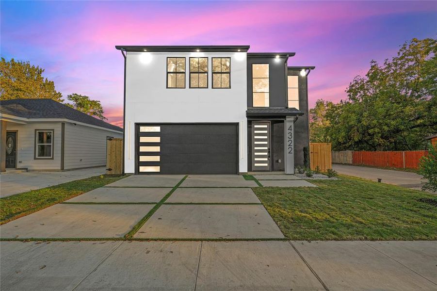 Contemporary house with a garage and a yard