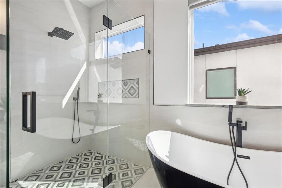 Bathroom with shower with separate bathtub, tile patterned floors, a wealth of natural light, and tile walls