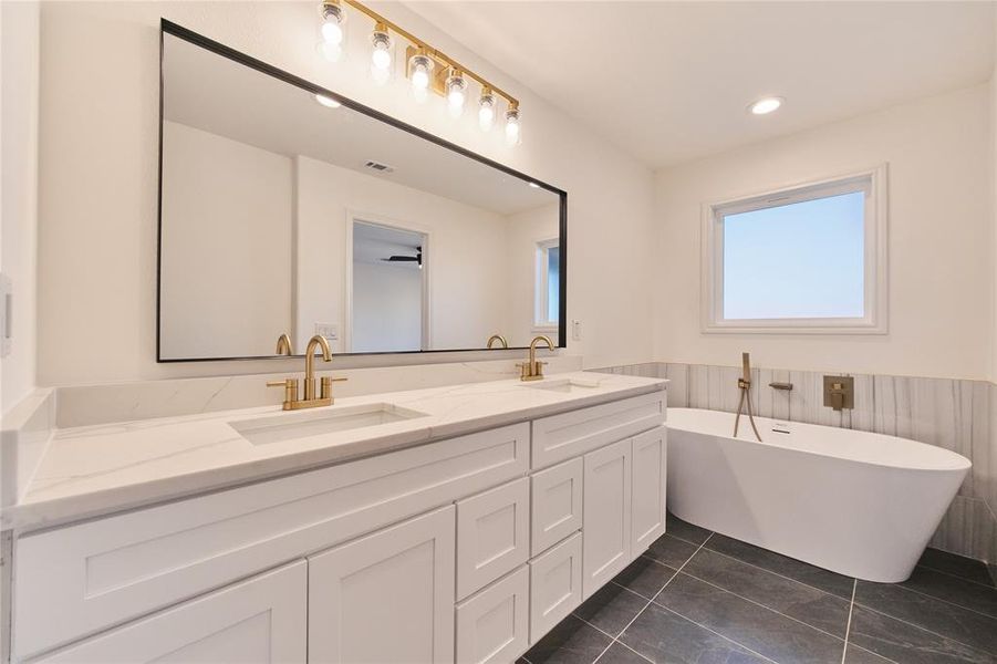 Bathroom with vanity, a bath, and tile patterned floors