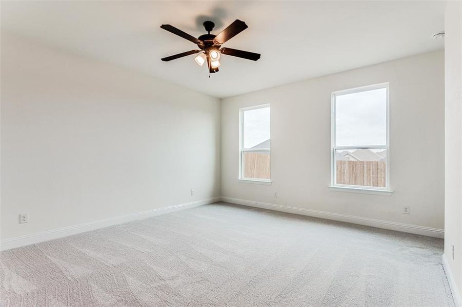 Unfurnished room with ceiling fan and carpet floors