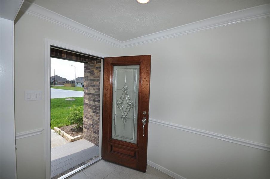 Attractive triple pane mahogany entry door welcomes your guests into the Foyer for a proper greeting.