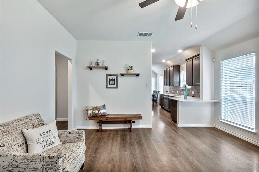 Living area featuring hardwood / wood-style floors, plenty of natural light, and ceiling fan