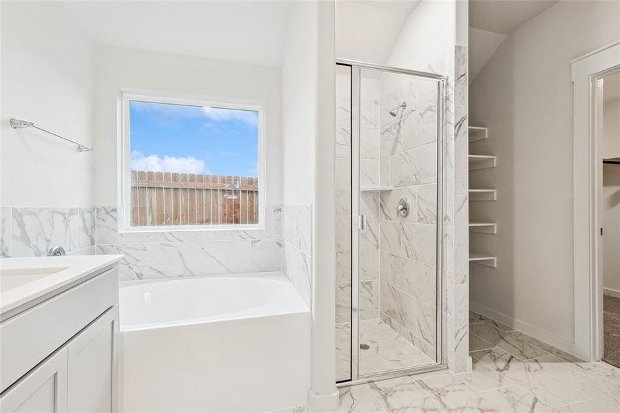 Bathroom featuring independent shower and bath, tile patterned floors, and vanity