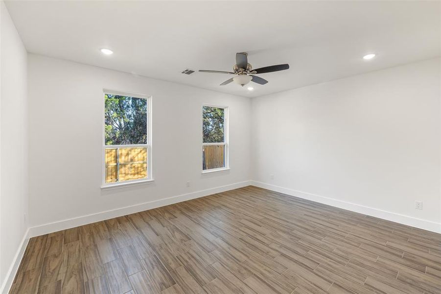 Empty room with light wood-type flooring and ceiling fan