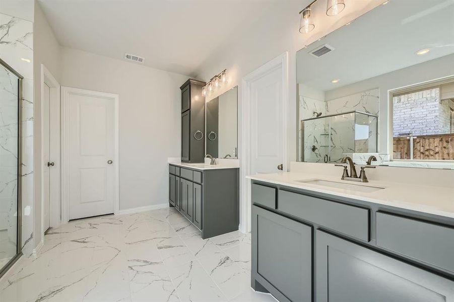 Bathroom featuring vanity and a shower with shower door