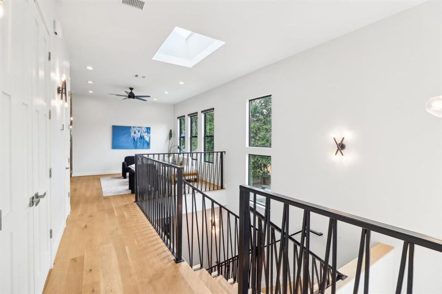 The upper landing of the stairwell is a visually attractive space. there is a skylight positioned over the stairwell which enhances lighting both in this room and below.
