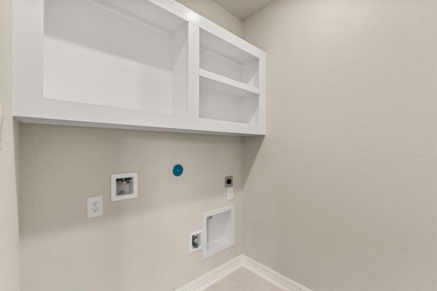 The laundry room layout is carefully planned for optimal workflow with designated areas for washing, drying, and storing.