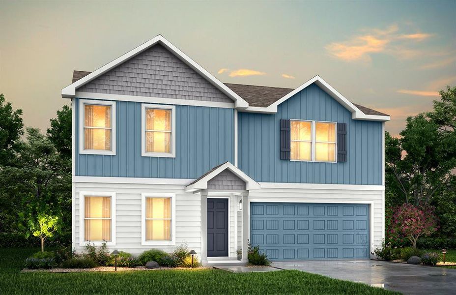 View of front facade featuring a garage and a yard