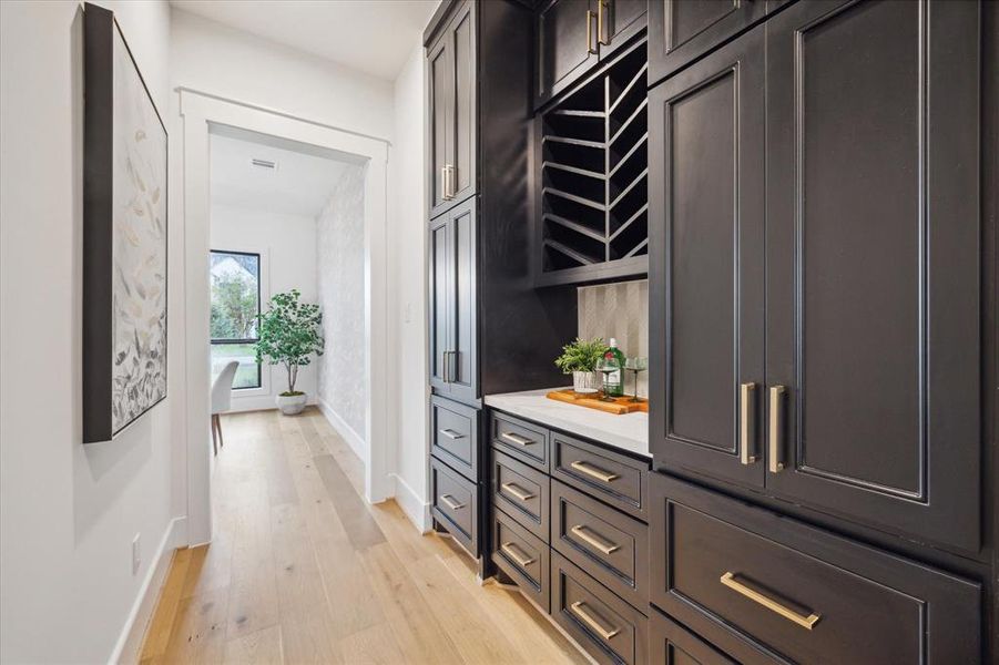 The extensive butlers pantry features drawers, cabinets, quartz counters and a wine storage area.