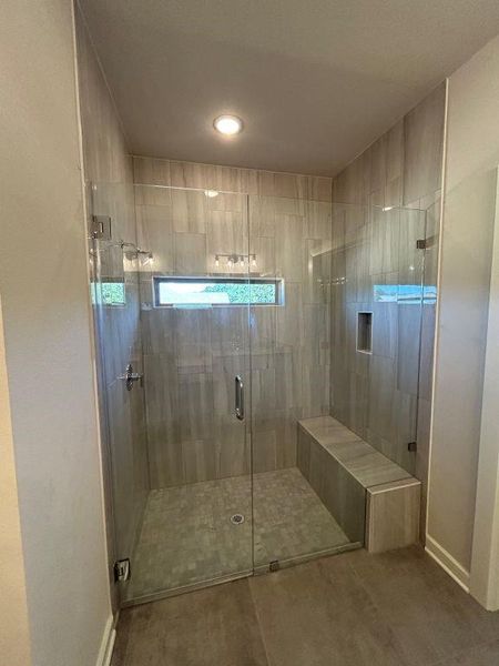 Bathroom featuring a shower with door