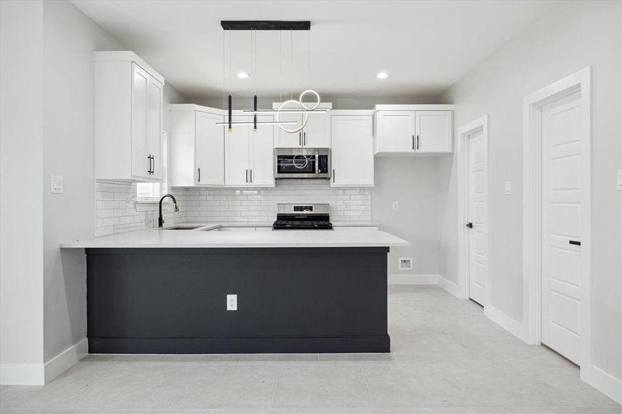 The kitchen includes matte black finishes