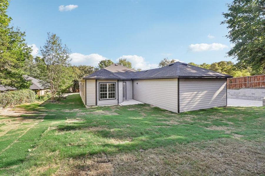 Rear view of property featuring a yard