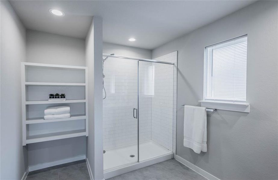 Primary bath w/oversized shoer and charming shelving to keep you organized.