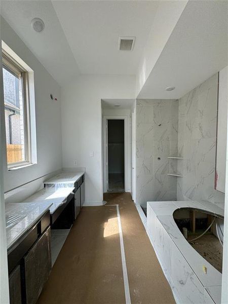 HOME IN PROGRESS - Stunning primary bathroom with his and her sinks and vanity area!