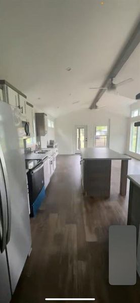 Kitchen with a center island, ceiling fan, dark wood-type flooring, appliances with stainless steel finishes, and white cabinets