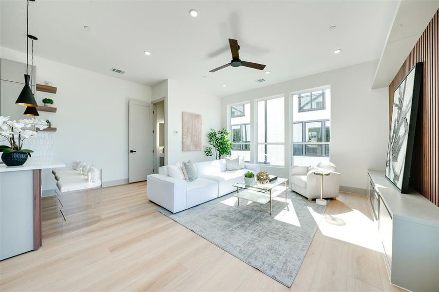 Living room featuring light wood-type flooring and ceiling fan