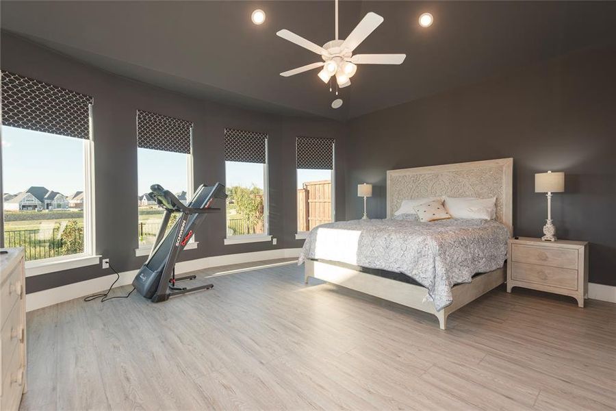 Bedroom with ceiling fan and light hardwood / wood-style floors