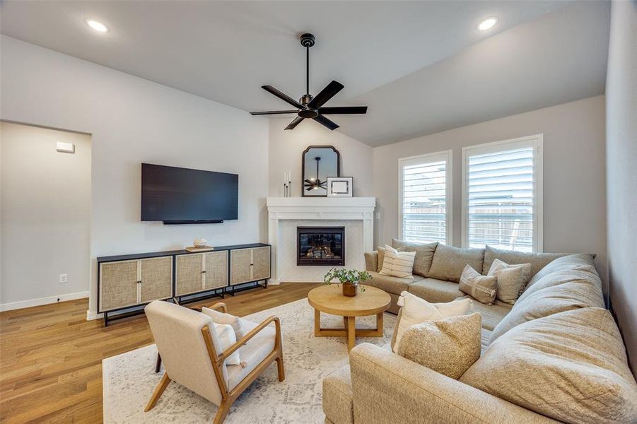 Living room with a fireplace and ceiling fan