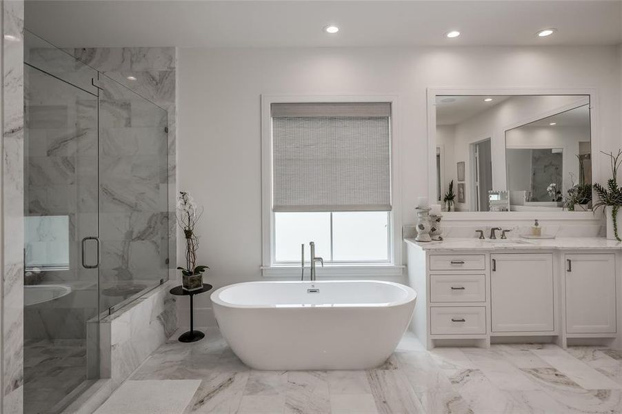 The primary bath features this stand-alone soaking tub.