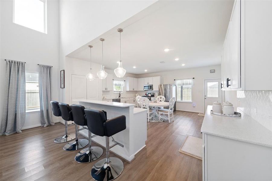 This home was built for entertaining!!  Kitchen bar for additional seating and access to the cook, with plenty of space for your breakfast table in the heart of the kitchen.