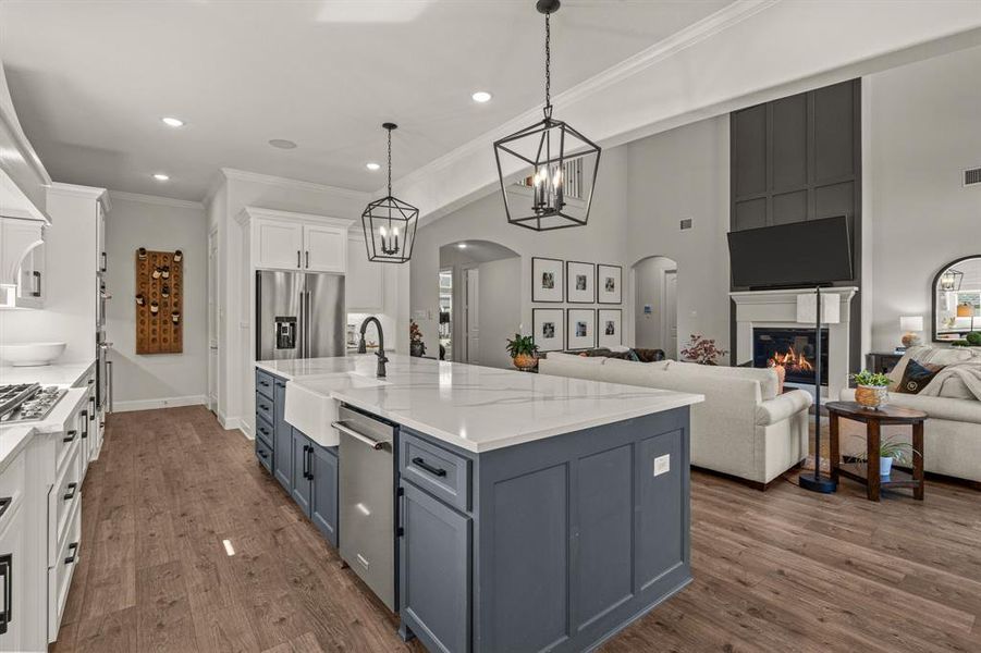 Kitchen with sink, dark hardwood / wood-style flooring, hanging light fixtures, white cabinetry, and stainless steel appliances