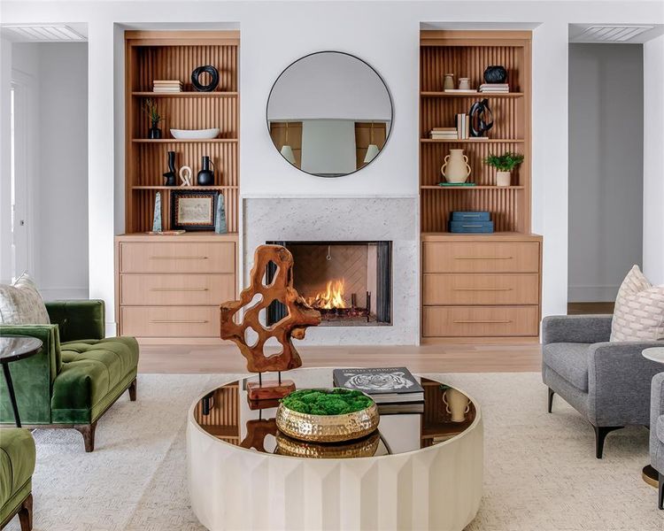 Living room with hardwood / wood-style flooring and built in shelves