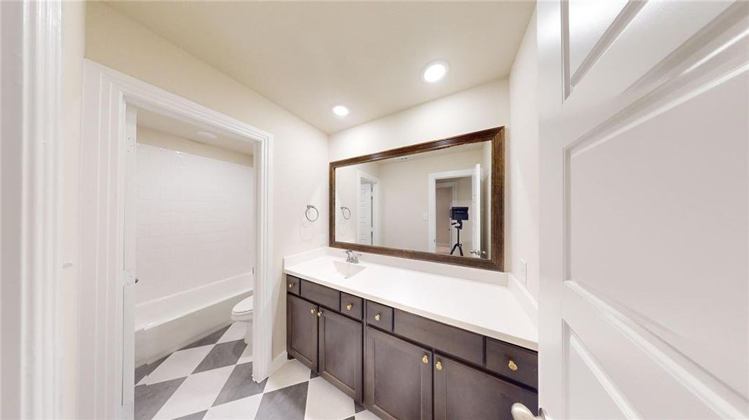 Full bathroom featuring vanity, bathing tub / shower combination, and toilet