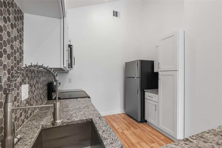 View of the kitchen with ample cabinet space and sleek design.